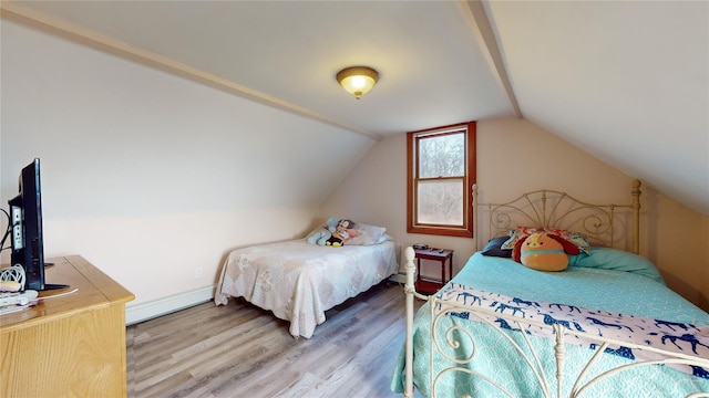 bedroom with wood-type flooring, lofted ceiling, and a baseboard heating unit