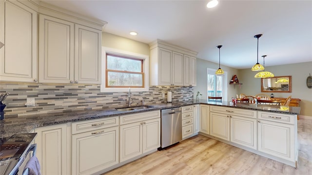 kitchen with dishwasher, kitchen peninsula, sink, and cream cabinets