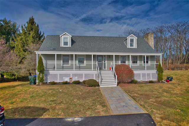 view of front of property with covered porch and a front yard