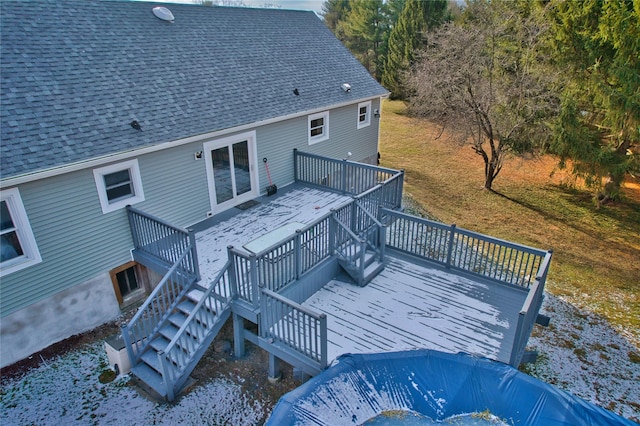 rear view of house featuring a lawn and a wooden deck