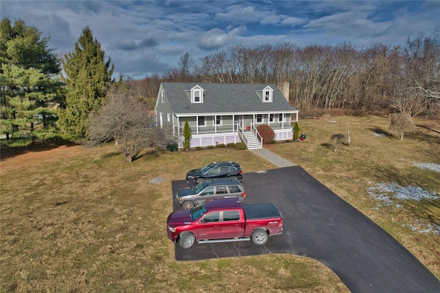 view of front of house featuring a porch and a front lawn