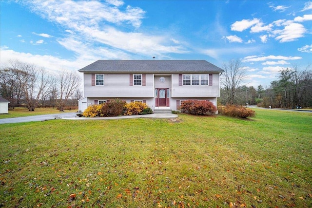 raised ranch featuring a front lawn