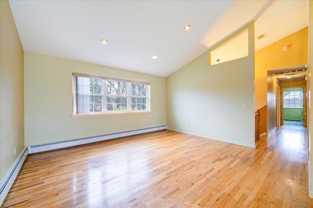 spare room with light hardwood / wood-style floors, baseboard heating, and high vaulted ceiling