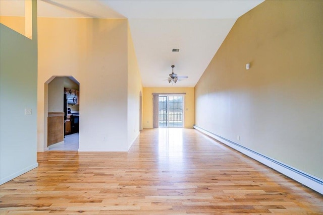 interior space with baseboard heating, ceiling fan, high vaulted ceiling, and light wood-type flooring