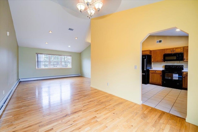 kitchen with high vaulted ceiling, an inviting chandelier, black appliances, baseboard heating, and light hardwood / wood-style floors