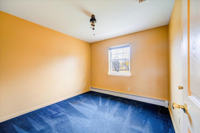 carpeted spare room featuring a baseboard heating unit