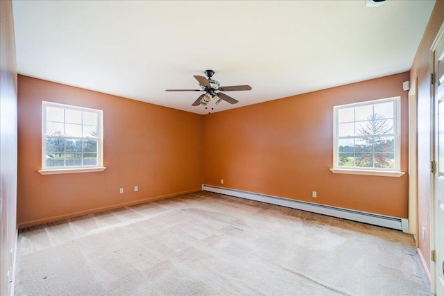 carpeted empty room featuring baseboard heating and ceiling fan