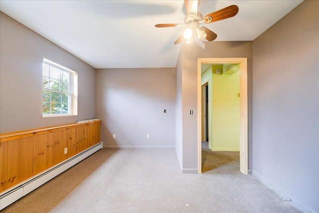 unfurnished room with ceiling fan, light colored carpet, and a baseboard radiator