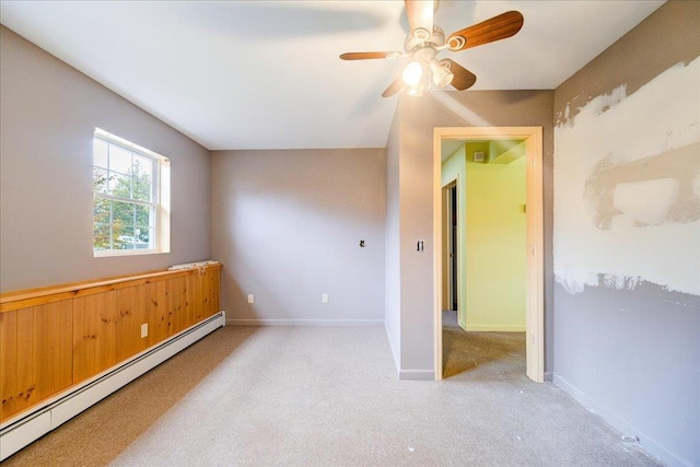 unfurnished room featuring ceiling fan, light colored carpet, and a baseboard heating unit