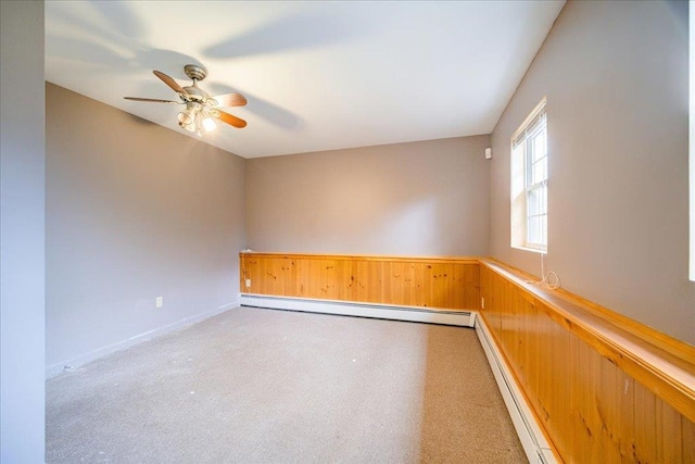 unfurnished room with baseboard heating, ceiling fan, and carpet flooring