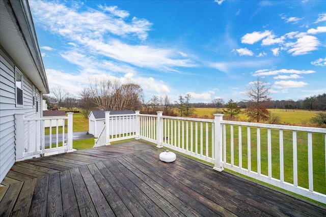 wooden deck with an outdoor structure and a yard