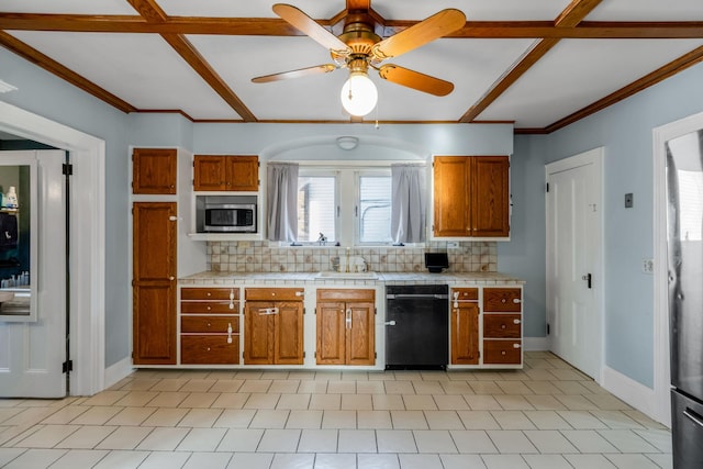 kitchen featuring decorative backsplash, ornamental molding, ceiling fan, tile countertops, and black dishwasher