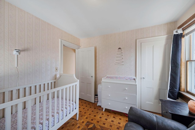 bedroom featuring a crib