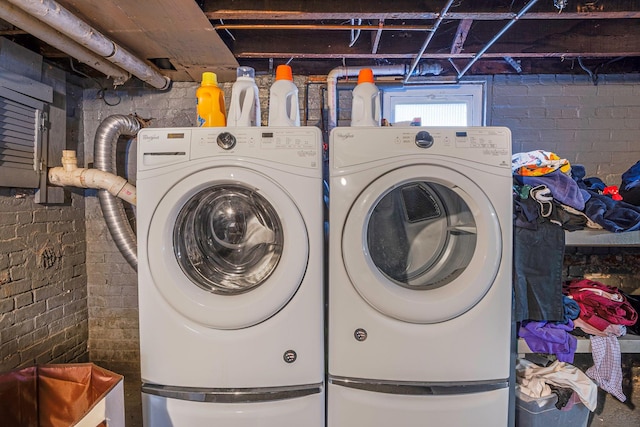 clothes washing area featuring washer and clothes dryer