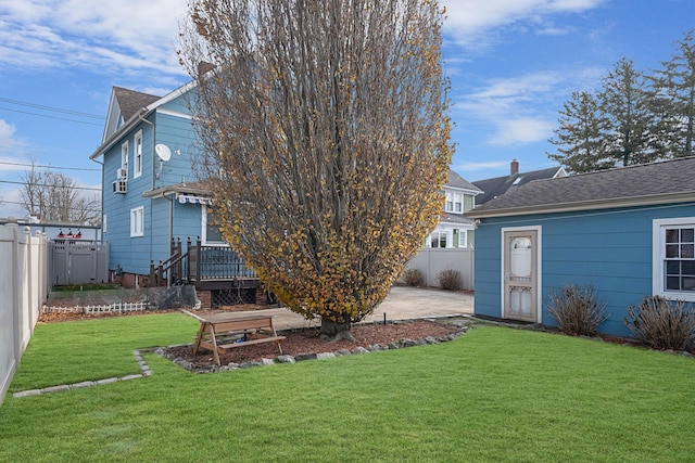 back of property with a patio area, a deck, and a yard