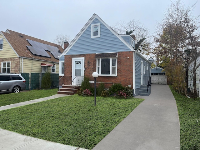 bungalow featuring brick siding, a detached garage, solar panels, driveway, and an outdoor structure