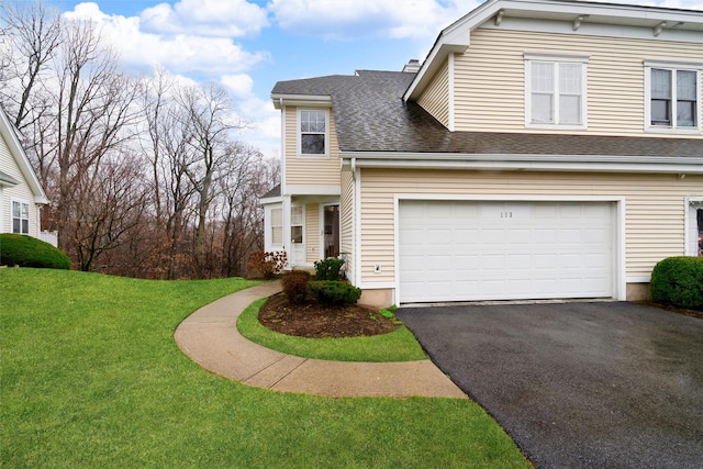 view of front of property featuring a garage and a front lawn