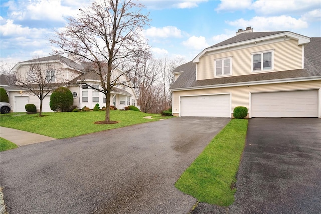 view of front of house with a garage and a front lawn