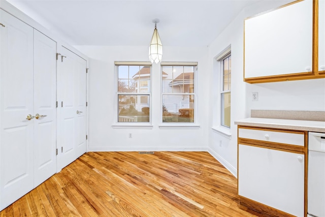 unfurnished dining area featuring light hardwood / wood-style floors