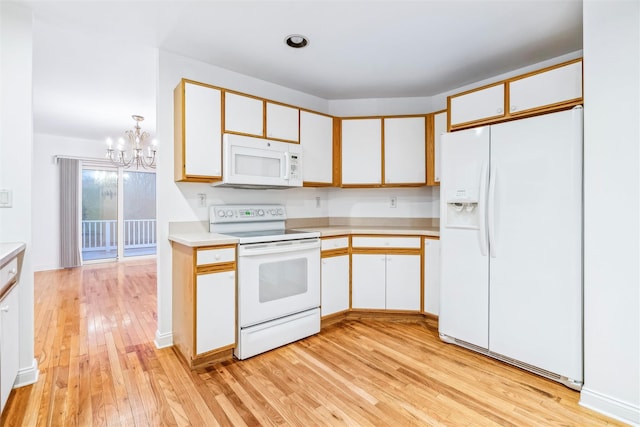 kitchen with white appliances, white cabinets, light hardwood / wood-style flooring, decorative light fixtures, and a chandelier