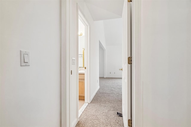 hallway featuring light colored carpet