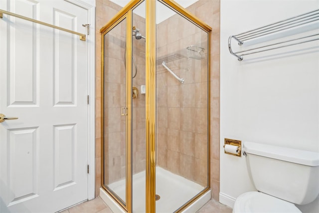 bathroom featuring tile patterned floors, an enclosed shower, and toilet