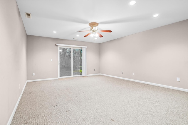 carpeted spare room with ceiling fan