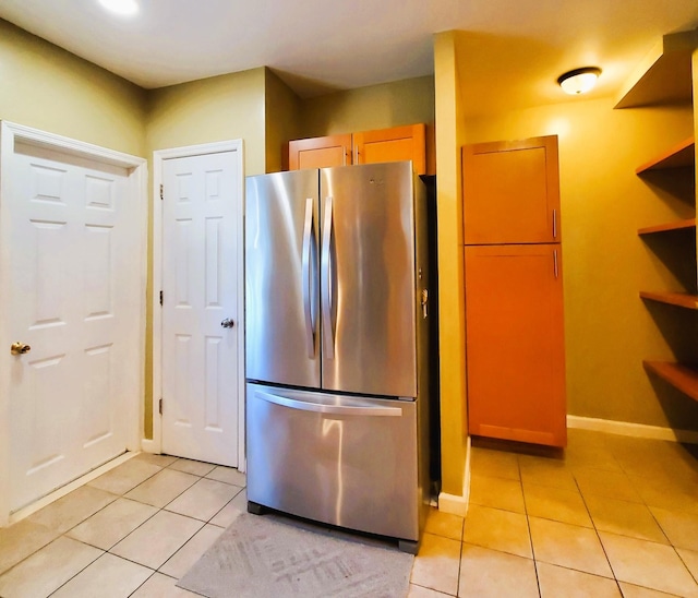 kitchen featuring stainless steel fridge and light tile patterned floors