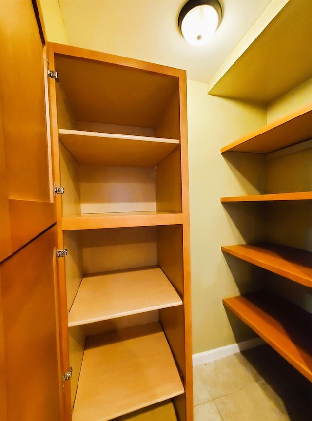 walk in closet with light tile patterned flooring