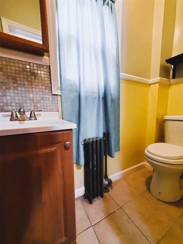 bathroom featuring backsplash, radiator, vanity, tile patterned flooring, and toilet