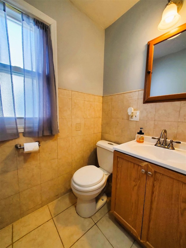 bathroom with tile patterned floors, vanity, tile walls, and toilet