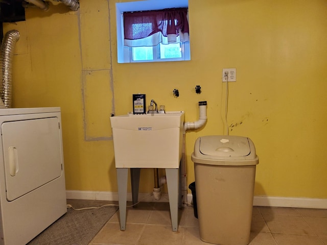 laundry room featuring light tile patterned floors and sink