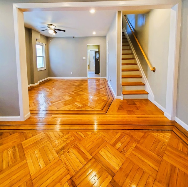 unfurnished room featuring ceiling fan and light parquet flooring