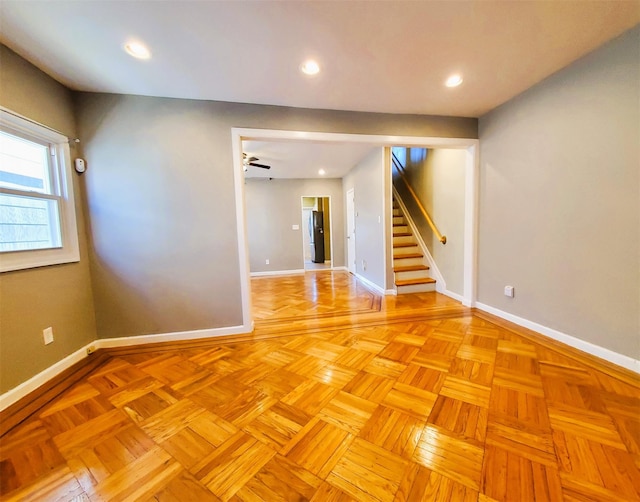 unfurnished room with ceiling fan and light parquet flooring