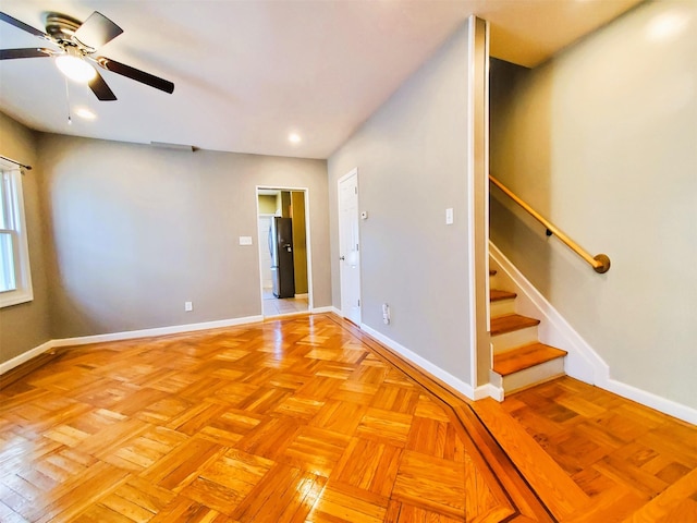 spare room with light parquet floors and ceiling fan