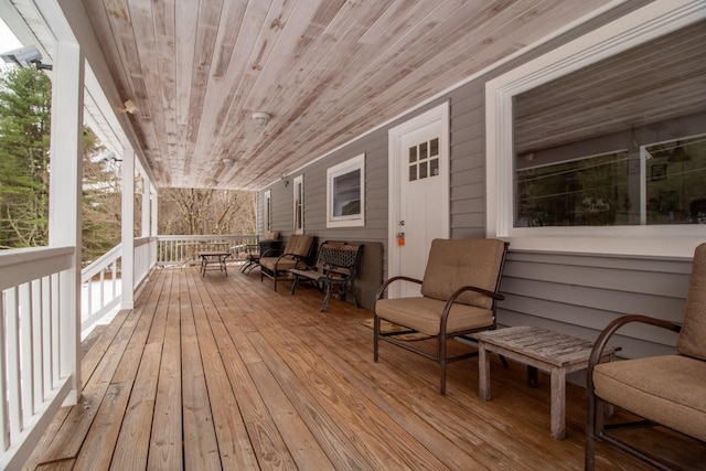 wooden terrace with outdoor lounge area and covered porch