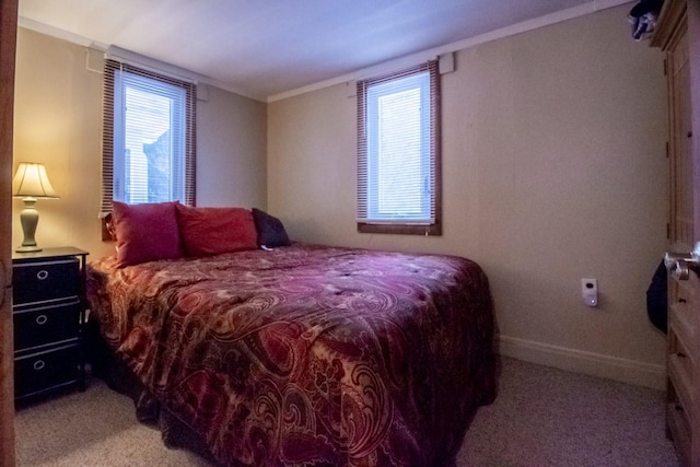 bedroom with light carpet and crown molding