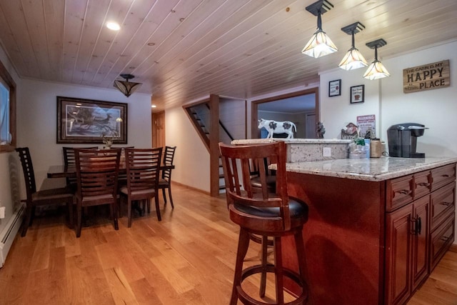 bar with decorative light fixtures, wooden ceiling, and light hardwood / wood-style flooring