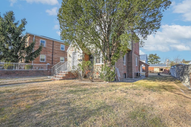 rear view of property featuring a yard and a patio