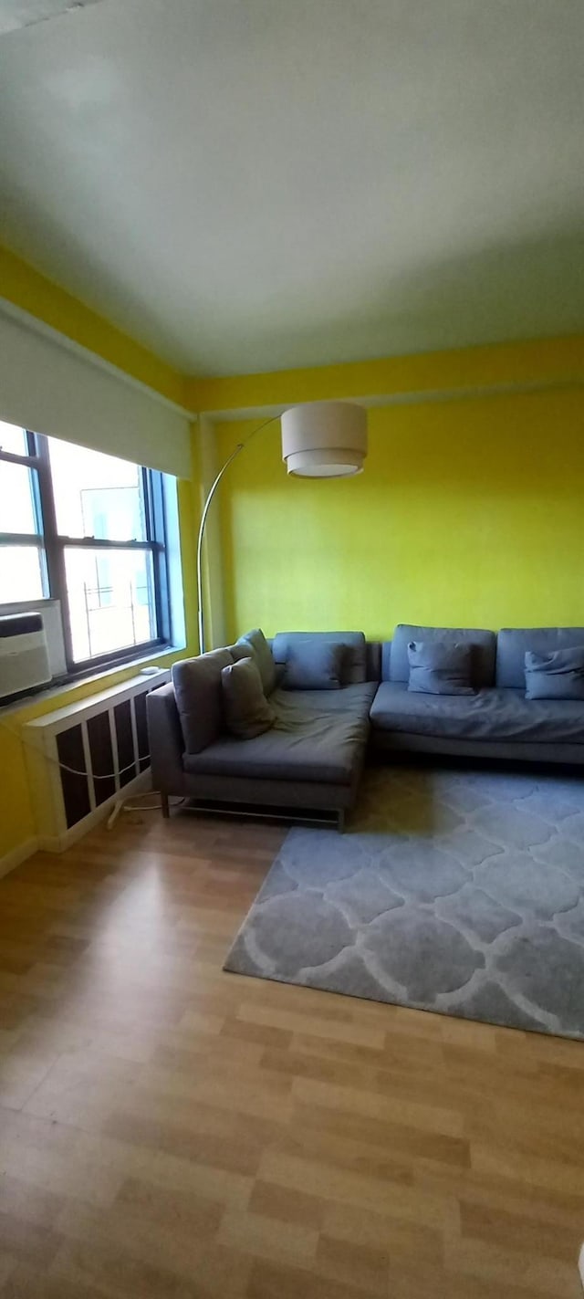 living room featuring cooling unit and hardwood / wood-style floors