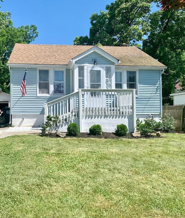 rear view of house featuring a yard