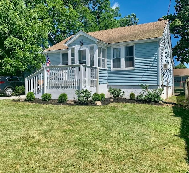 view of front of property with a front lawn and a sunroom