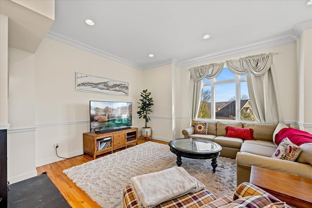 living room with light wood-type flooring and ornamental molding