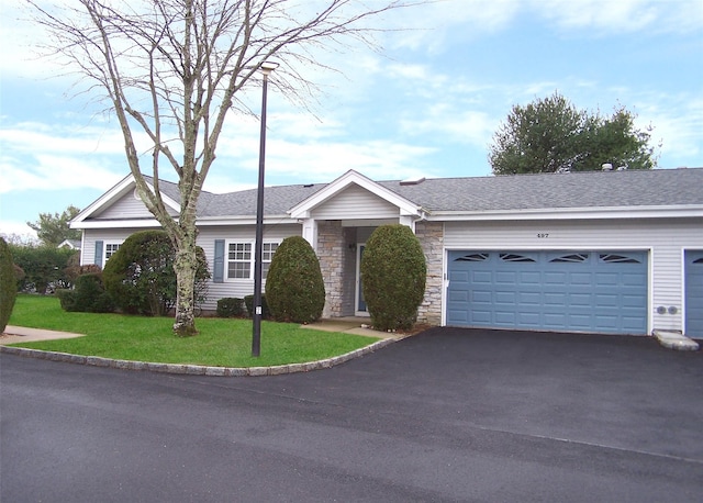 ranch-style house with a garage and a front lawn