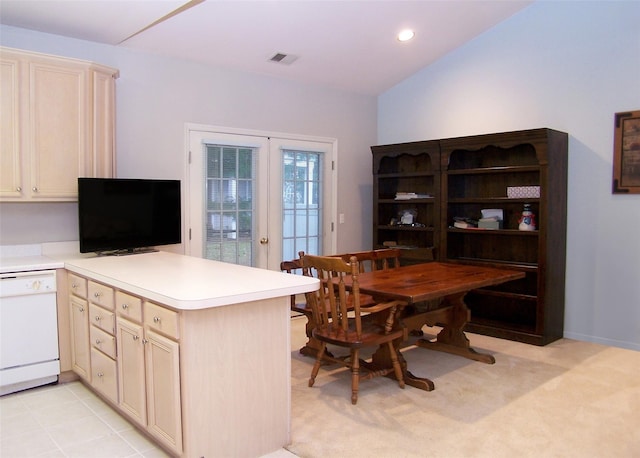 kitchen featuring kitchen peninsula, french doors, lofted ceiling, and dishwasher