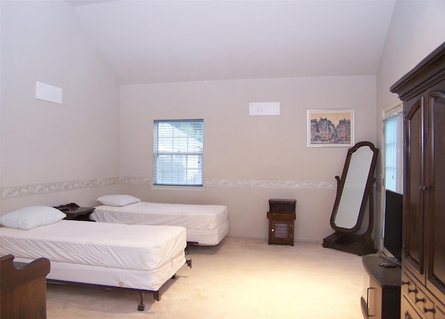 carpeted bedroom featuring vaulted ceiling