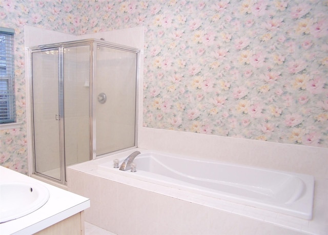 bathroom featuring plus walk in shower and vanity