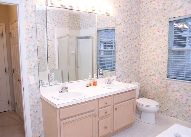 bathroom with toilet, vanity, tile patterned floors, and walk in shower