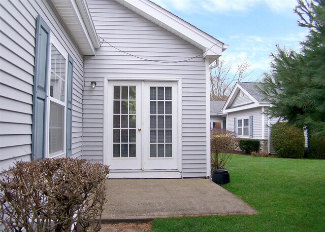 property entrance with a lawn and french doors