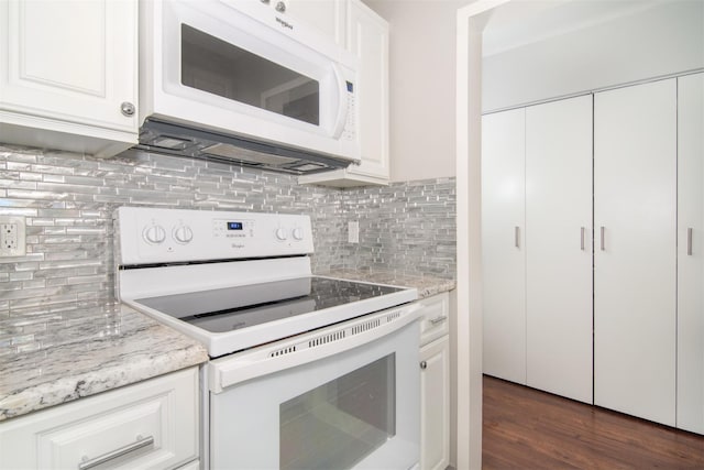 kitchen featuring light stone countertops, white appliances, and white cabinetry